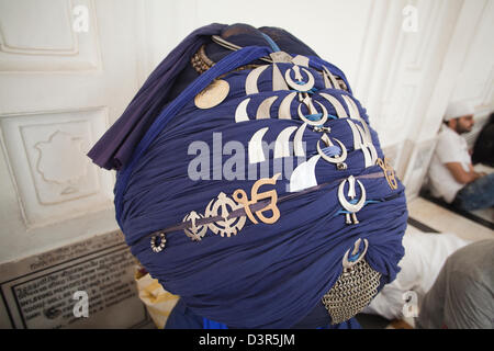Close-up de el turbante de un sij Nihang con símbolos religiosos, Templo de Oro de Amritsar, Punjab, India Foto de stock