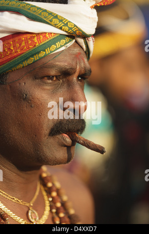 Devoto hindú fumar cigarro Thaipusam anual festival religioso en las Cuevas Batu, cerca de Kuala Lumpur, Malasia. Foto de stock