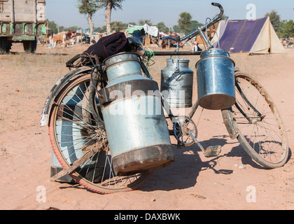 Bicicleta con botes de leche en su lado en Nagaur la feria de ganado en Rajasthan. Foto de stock