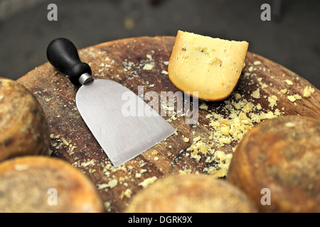Cuchillo especial y famoso italiano queso pecorino en la pequeña mesa de madera. Foto de stock