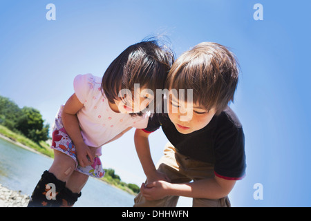 Niño y niña mirando algo Foto de stock