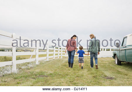 Familia de tres "caminar juntos en la granja
