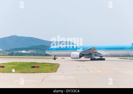 Un avión coreano los taxis a la pista para prepararse para el despegue. Foto de stock