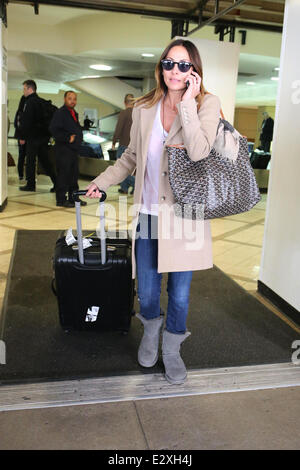 Natalie Imbruglia arrives with luggage and a Goyard tote at LAX