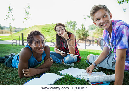 Los adolescentes haciendo los deberes en hierba