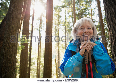 Retrato de mujer senior sonriente caminatas en el bosque