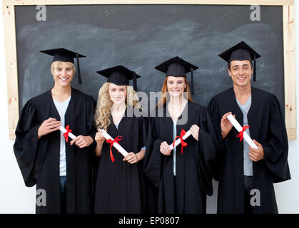 Grupo de adolescentes celebrando después de graduarse Foto de stock