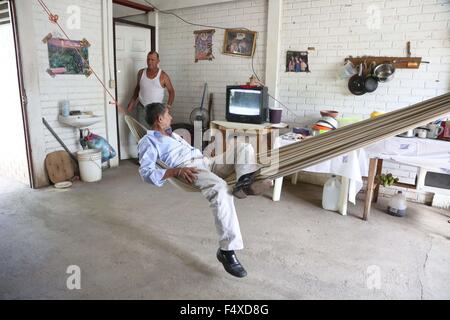 Managua. 22 Oct, 2015. Imagen tomada en el pasado 22 de octubre, 2015 muestra José Castillo (delantero) descansando en una hamaca en su casa en la ciudadela "héroes y mártires de nemagón" en Managua, Nicaragua. La ciudadela "héroes y mártires de nemagón" fue beneficiado por las "Casas para el pueblo", un programa, implementado desde 2007 y consiste en la construcción y la prestación de servicios sociales a la población de los hogares en situación de pobreza que viven en las zonas rurales y urbanas. © Juan Bustos/Xinhua/Alamy Live News