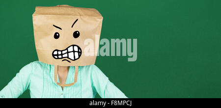 Imagen compuesta de mujer cubriendo la cabeza con bolsas de papel marrón Foto de stock