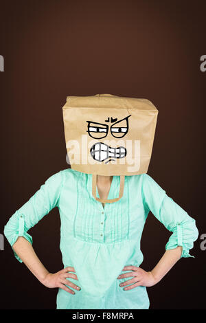 Imagen compuesta de mujer cubriendo la cabeza con bolsas de papel marrón Foto de stock