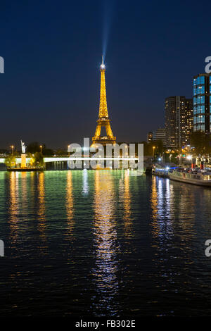 Vista nocturna del río Sena con edificios de gran altura, en la orilla izquierda, y la Torre Eiffel, en París, Francia, Europa