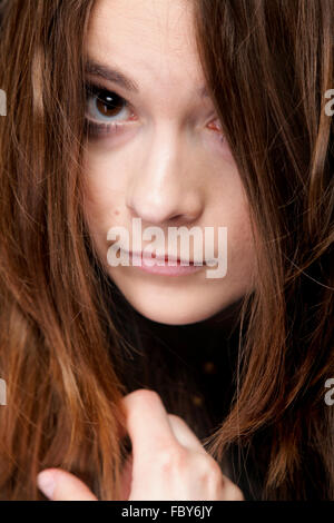 Closeup mujer cubre el rostro por largos pelos marrones