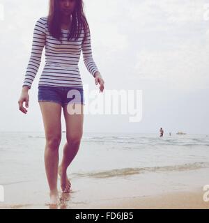 Mujer joven caminando en la playa