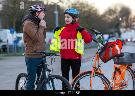 Ciclista ponga en ropa de seguridad, casco y chaleco reflectante de  seguridad en bicicleta, una buena visibilidad por la noche en el tráfico  Fotografía de stock - Alamy