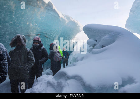 La gente en la entrada de una cueva de hielo, Parque Nacional, el glaciar de Vatnajökull, Islandia