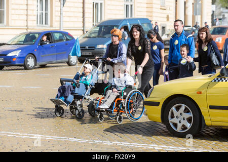 Sofia, Bulgaria - Abril 6, 2016: Discapacitados físicos y mentales están acompañados por sus padres, parientes y amigos en una p Foto de stock