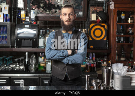 Barman al trabajo con los brazos cruzados. Foto de stock