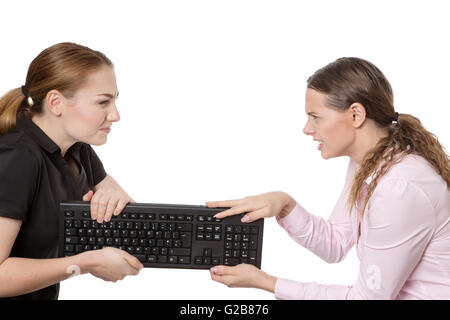 Foto de estudio de dos modelos de negocio que tenga un desacuerdo y tirando en un teclado aislado en blanco.