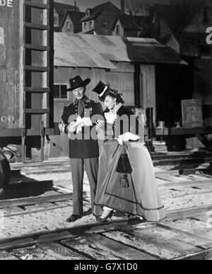 Errol Flynn y Olivia de Havilland en una escena de la película murieron con sus botas. Foto de stock
