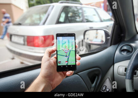 Velika Gorica, Croacia. El 15 de julio, 2016. : Un jugador utilizando un smartphone para jugar Pokemon ir mientras conduce un automóvil. Pokemon Go es un free-to-play móvil de realidad aumentada juego desarrollado por Nintendo. Crédito: PhotoJa/Alamy Live News