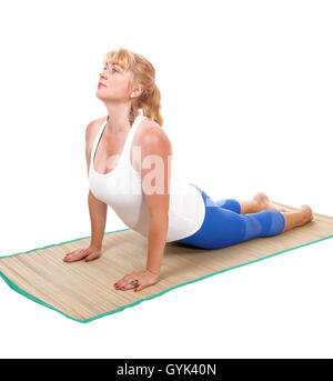 Una hermosa mujer rubia es yoga outfit tumbado sobre su estómago mostrando  algunos ejercicios de yoga, aislados en fondo blanco Fotografía de stock -  Alamy