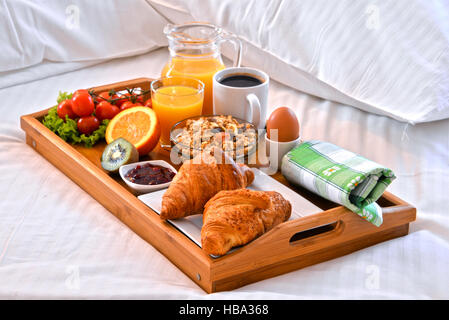 Bandeja de cama con desayuno para dos en una cama doble en un
