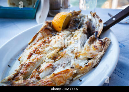 Deliciosas parrilladas de pescado fresco servidos en una tabla en una taberna frente al mar en la Bahía de Ammoudi, Oia, Santorini, una isla griega en el Mediterráneo Cyclades grou