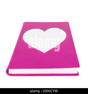 Corazón de papel en purple book aislado sobre fondo blanco ,el enfoque selectivo Foto de stock