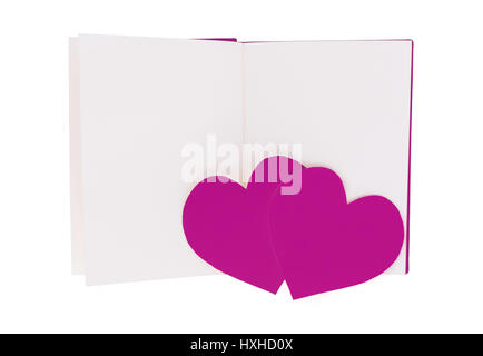 Par de papel morado en corazón aislado de libro abierto en blanco sobre fondo blanco. Foto de stock