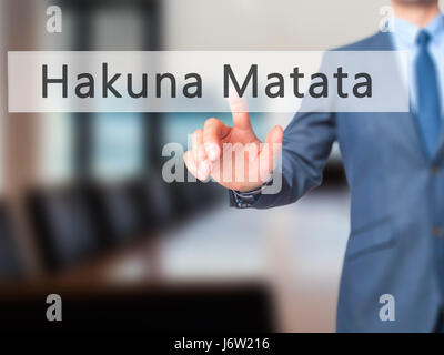 Hakuna Matata (frase swahili significa sin preocupaciones) - El empresario mano pulsando el botón en la interfaz de pantalla táctil. Negocios, tecnología, internet conce Foto de stock