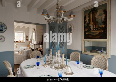 Candelabros de plata en la mesa de comedor con rincón, armario y espejo trumeau francés del siglo XVIII.