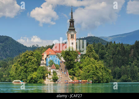 Bled, Eslovenia - Junio 3, 2017: Cerca de la iglesia en el centro de lago de Bled con varios turistas caminando por ahí. Foto de stock