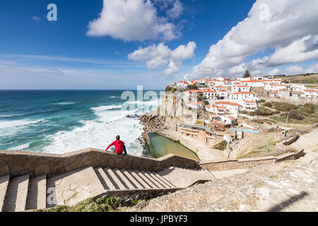 Turista admira la posado aldea de Azenhas do Mar rodeado por el agua azul del océano Atlántico Sintra Portugal Europa