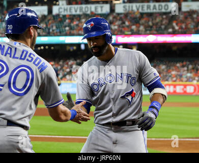 Toronto Blue Jays Josh Donaldson (L), Troy Tulowitzki (C), and Ryan Goins  celebrate defeating the Cleveland Indians in game four of the American  League Championship Series at Rogers Centre on October 18