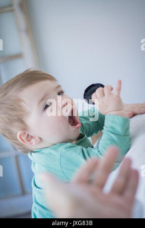 Niño atrapado intentando comer algo que no debería. Foto de stock