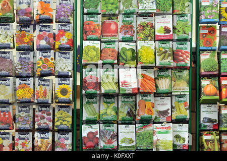 Semillas en paquetes para la venta en un stand con diferentes paquetes de coloridas flores de frutas y verduras para cultivar su propio en la afición de jardinería