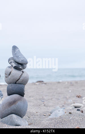 Monocromo Azul, sereno, rocas apiladas en una playa de California que simbolizan la paz, equilibrio, meditación y Mindfulness Foto de stock