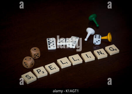 Palabra azulejos deletrear 'SPELLING', diversos juegos de tablero de parafernalia está cerca. Foto de stock
