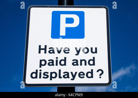 Un cartel preguntando si los conductores han pagado y se visualiza en una pantalla y pagar aparcamiento. Foto de stock
