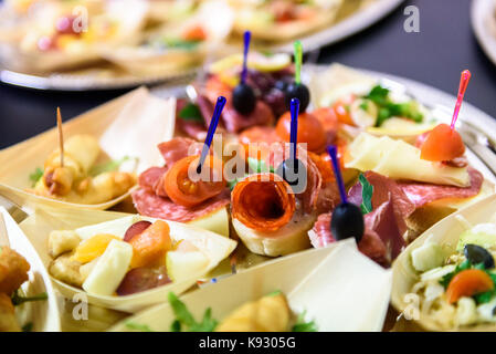 Canapés caseros sandwiches pequeños aperitivos. Mezcla de diferentes finger food bocadillos para una fiesta o banquete en una placa.