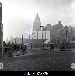 A principios del decenio de 1950, foto histórica por J Allan efectivo, una vista de la famosa calle, el Headrow, Leeds, Inglaterra, Reino Unido, con la torre del reloj del gran edificio del Ayuntamiento en la distancia.