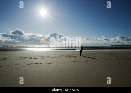 Hombre de pie sobre la caída de Sands Beach en un nítido, claro día de otoño Foto de stock