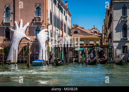 Ilustración titulada "Apoyo" emerge del Gran Canal, por Lorenzo Quinn. La escultura contemporánea de manos gigantescas, 2017 Bienal de Venecia. Foto de stock
