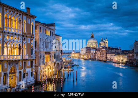 Vista clásica del famoso Canal Grande con la histórica Basílica di Santa Maria della Salute, en el fondo en penumbra, Venecia, Italia