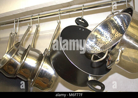 https://l450v.alamy.com/450ves/m6f77f/las-ollas-y-sartenes-colgando-de-una-rampa-en-una-cocina-domestica-m6f77f.jpg