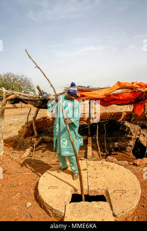 UBTEC ONG en una aldea cerca de Ouahigouya, Burkina Faso. Dirigente cooperativista Cissé Ousseini utilizando estiércol de ganado para producir biogaz. Foto de stock