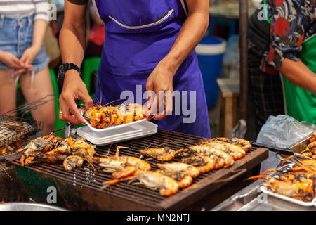 CHIANG MAI, Tailandia - 27 de agosto: el hombre preparar langostinos a la venta en el mercado de sábado por la noche en Chiang Mai (Calle) el 27 de agosto de 2016 en Chian Foto de stock