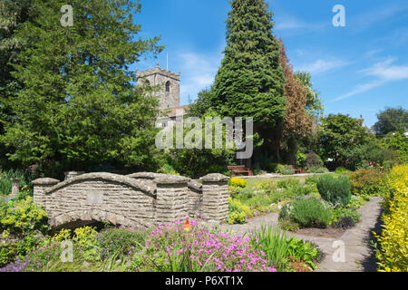 Waddington, Clitheroe, Lancashire, Reino Unido. Bonitos jardines en el centro del pueblo con la torre de la iglesia en el fondo. Foto de stock