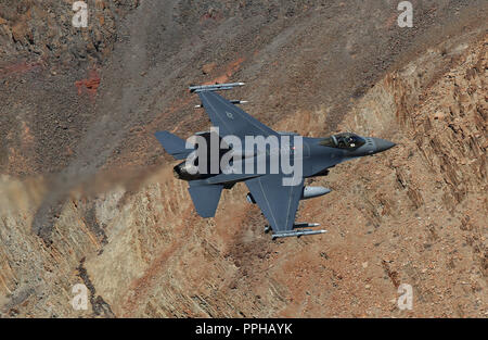 La Fuerza Aérea de EE.UU. F-16C combates Falcon de Edwards AFB vuela una incursión de bajo nivel a través de la barranca en Star Wars Jedi transición en Death Valley CA Foto de stock