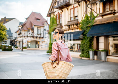 Bella mujer caminando en el casco antiguo de la ciudad de Deauville, famoso balneario francés en Normandía